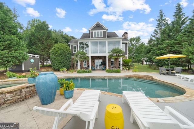 202 Jackson Rd SE, Milledgeville, GA 31061 - outdoor pool featuring a patio, outdoor dining space, a sunroom, and an outbuilding