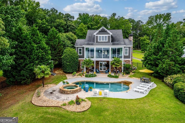 202 Jackson Rd SE, Milledgeville, GA 31061 - rear view of property featuring a patio, a chimney, stone siding, a balcony, and a pool with connected hot tub