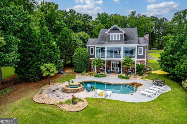 202 Jackson Rd SE, Milledgeville, GA 31061 - back of property with stone siding, a patio area, a chimney, a pool with connected hot tub, and a balcony