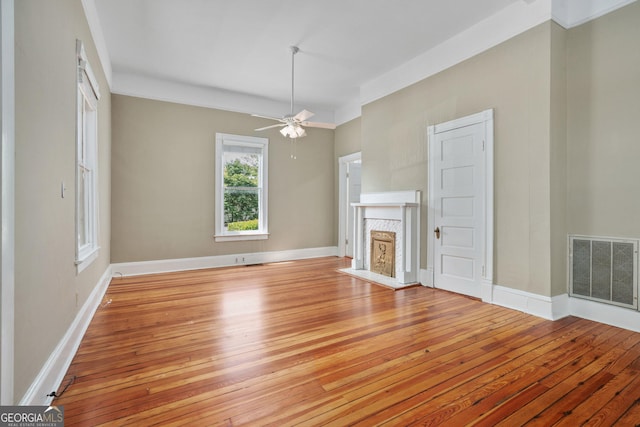 124 Hines Ter, Macon, GA 31204 - unfurnished living room featuring light wood-style flooring, ceiling fan, and a fireplace with flush hearth
