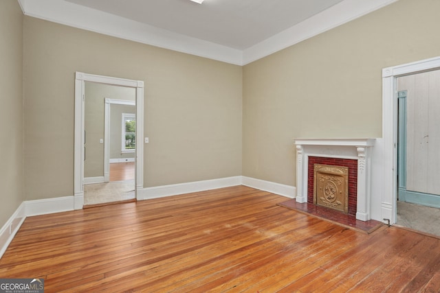 124 Hines Ter, Macon, GA 31204 - unfurnished living room with light wood-style flooring and a fireplace with raised hearth