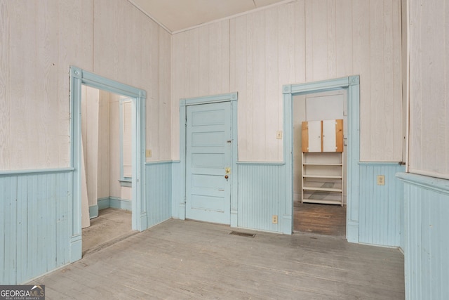 124 Hines Ter, Macon, GA 31204 - unfurnished room with wood finished floors, wood walls, and a wainscoted wall