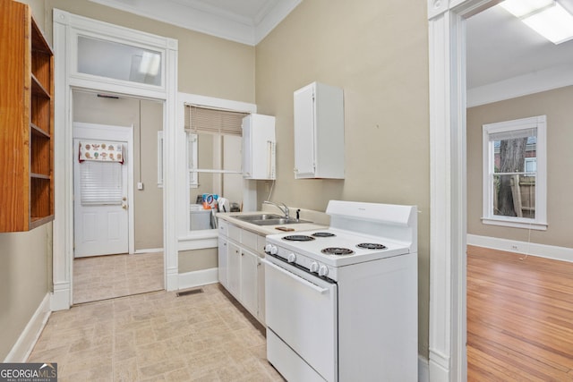 124 Hines Ter, Macon, GA 31204 - kitchen featuring white electric stove, crown molding, white cabinets, light countertops, and light wood-style floors