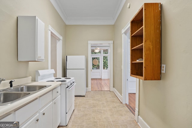 124 Hines Ter, Macon, GA 31204 - kitchen with white appliances, crown molding, light countertops, white cabinets, and light flooring