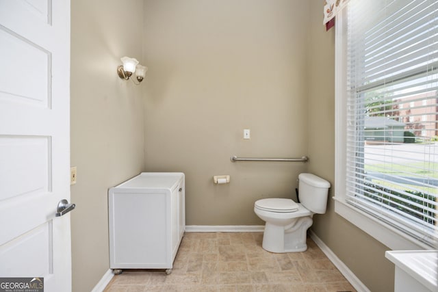 124 Hines Ter, Macon, GA 31204 - bathroom featuring toilet and baseboards