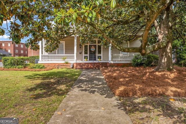 124 Hines Ter, Macon, GA 31204 - view of exterior entry featuring covered porch and a yard