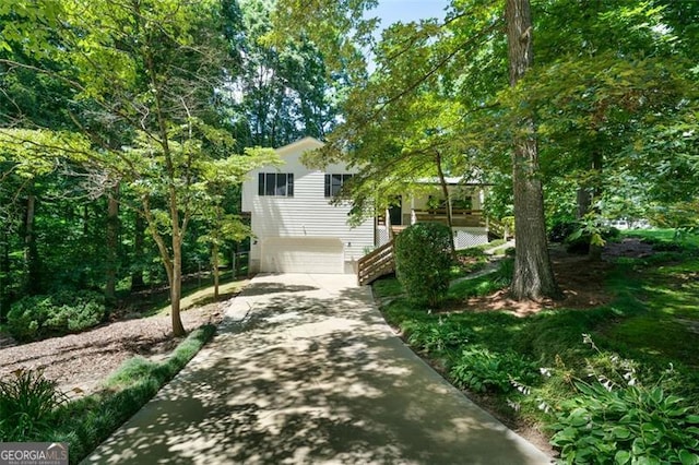 86 Kelly, Dallas, GA 30157 - view of property hidden behind natural elements featuring driveway, an attached garage, and stairs