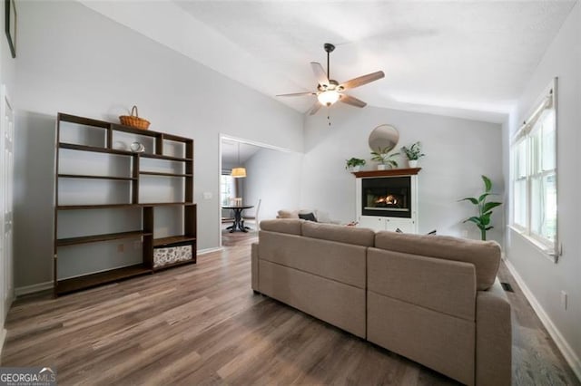 86 Kelly, Dallas, GA 30157 - living room with a ceiling fan, wood finished floors, a warm lit fireplace, and vaulted ceiling