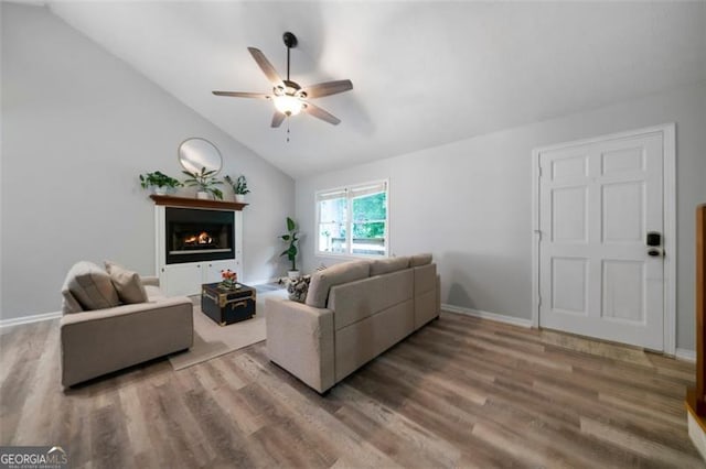 86 Kelly, Dallas, GA 30157 - living room with a ceiling fan, wood finished floors, lofted ceiling, and a warm lit fireplace