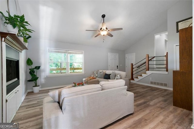 86 Kelly, Dallas, GA 30157 - living room featuring lofted ceiling, ceiling fan, light wood-style floors, and stairway