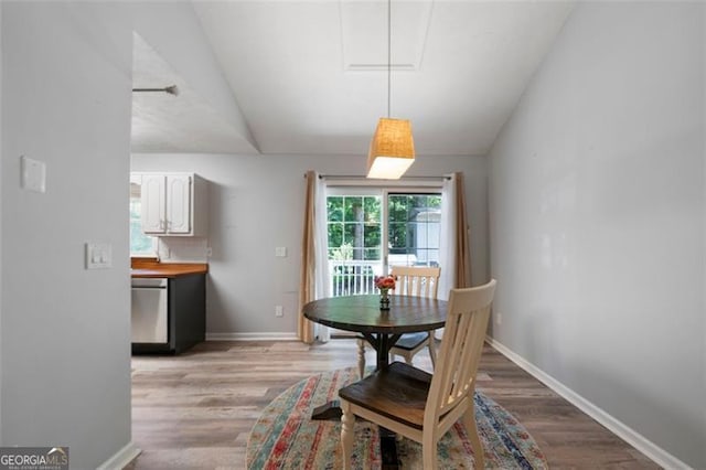 86 Kelly, Dallas, GA 30157 - dining space featuring light wood-style flooring, lofted ceiling, and attic access