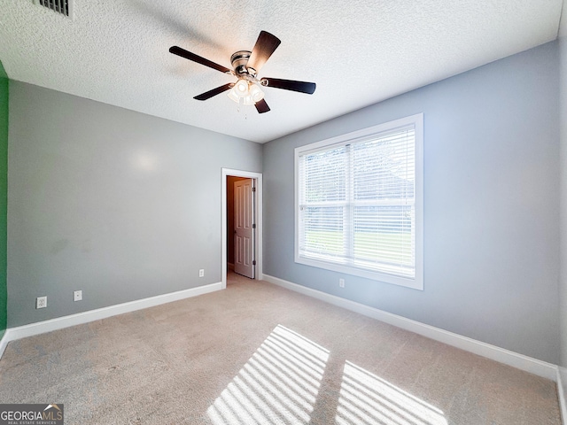 152 Huron Loop, Brunswick, GA 31523 - spare room featuring light colored carpet, ceiling fan, and a textured ceiling