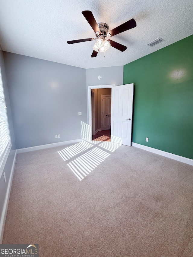 152 Huron Loop, Brunswick, GA 31523 - carpeted spare room featuring a textured ceiling and a ceiling fan