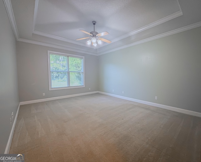 152 Huron Loop, Brunswick, GA 31523 - spare room featuring a raised ceiling, crown molding, a ceiling fan, and light carpet