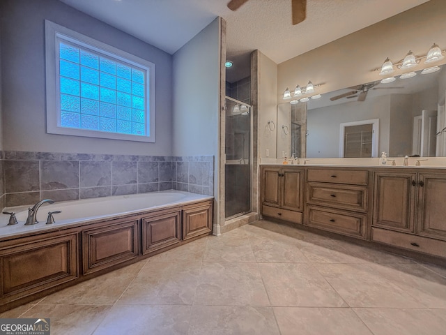 152 Huron Loop, Brunswick, GA 31523 - bathroom with a ceiling fan, a shower stall, double vanity, a bath, and tile patterned flooring