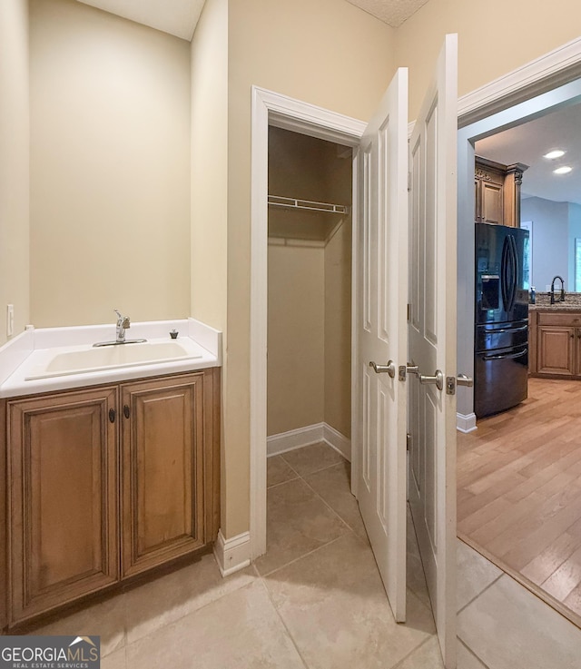 152 Huron Loop, Brunswick, GA 31523 - bathroom with tile patterned floors, vanity, and a walk in closet