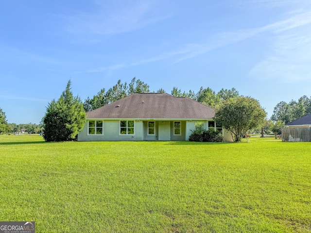 152 Huron Loop, Brunswick, GA 31523 - back of house with a yard and stucco siding