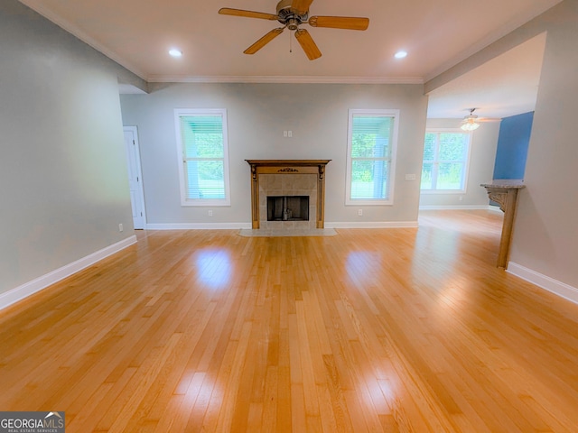 152 Huron Loop, Brunswick, GA 31523 - unfurnished living room featuring ceiling fan, a fireplace, light wood finished floors, and crown molding