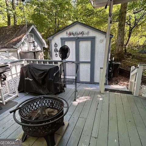 39 Terrace Cir, Cleveland, GA 30528 - deck featuring a fire pit, a shed, and a grill