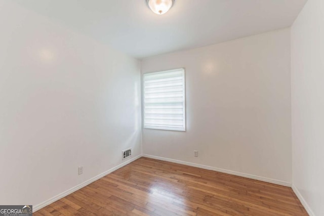 1784 Treymire Ct, Stone Mountain, GA 30088 - unfurnished room with wood finished floors and baseboards
