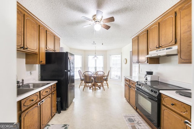 105 Shadow Ln, Warner Robins, GA 31088 - kitchen featuring black appliances, under cabinet range hood, brown cabinets, a ceiling fan, and a textured ceiling