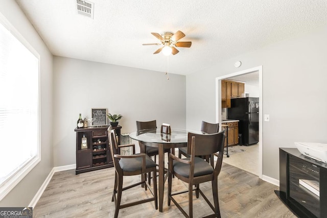 105 Shadow Ln, Warner Robins, GA 31088 - dining room featuring light wood-style flooring, ceiling fan, and a textured ceiling
