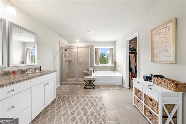 349 Garnet Dr, Acworth, GA 30101 - full bath featuring a stall shower, vanity, a garden tub, tile patterned flooring, and a spacious closet