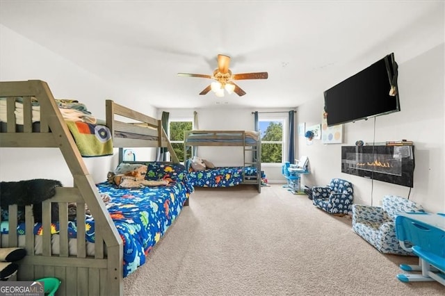 349 Garnet Dr, Acworth, GA 30101 - carpeted bedroom featuring a glass covered fireplace and ceiling fan