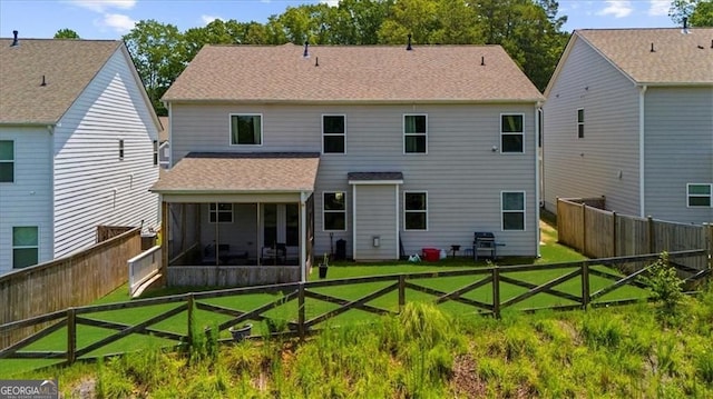 349 Garnet Dr, Acworth, GA 30101 - back of house featuring a sunroom, a shingled roof, and a fenced backyard