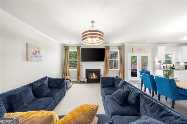 349 Garnet Dr, Acworth, GA 30101 - living room with a chandelier, crown molding, and a warm lit fireplace