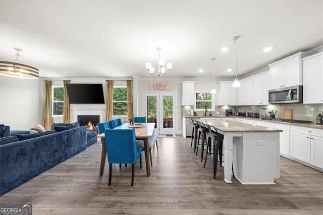 349 Garnet Dr, Acworth, GA 30101 - kitchen featuring stainless steel appliances, open floor plan, a center island, wood finished floors, and a breakfast bar