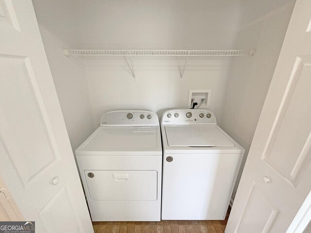 651 Walnut Woods Dr, Braselton, GA 30517 - laundry room with washer and dryer and wood finished floors