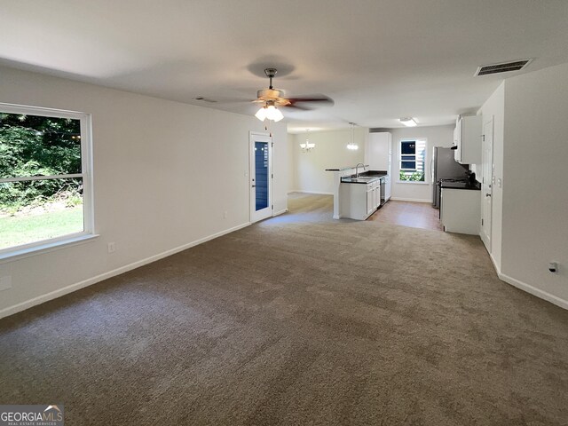 651 Walnut Woods Dr, Braselton, GA 30517 - unfurnished living room featuring light colored carpet and ceiling fan