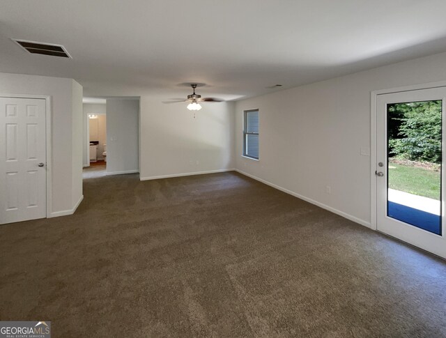 651 Walnut Woods Dr, Braselton, GA 30517 - unfurnished living room featuring dark carpet and ceiling fan