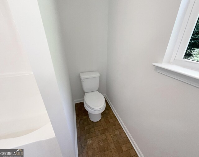 651 Walnut Woods Dr, Braselton, GA 30517 - full bathroom featuring toilet and brick patterned flooring