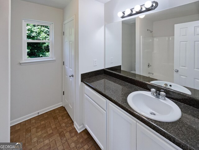 651 Walnut Woods Dr, Braselton, GA 30517 - full bath with vanity and brick patterned floors