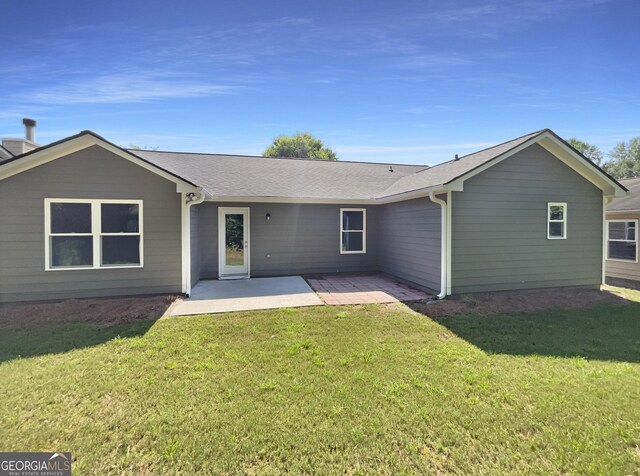 651 Walnut Woods Dr, Braselton, GA 30517 - rear view of house with a patio, a lawn, and a shingled roof