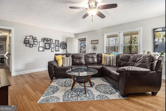 4352 Treeline Way, Douglasville, GA 30135 - living room featuring a textured ceiling, a ceiling fan, and hardwood / wood-style floors