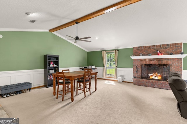 310 Ridge Rd, Kingsland, GA 31548 - carpeted dining space featuring a ceiling fan, a wainscoted wall, crown molding, a brick fireplace, and a decorative wall