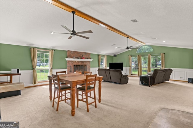 310 Ridge Rd, Kingsland, GA 31548 - dining area featuring a ceiling fan, wainscoting, carpet floors, a fireplace, and a textured ceiling