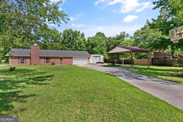 310 Ridge Rd, Kingsland, GA 31548 - ranch-style house featuring a chimney, concrete driveway, a garage, brick siding, and a carport