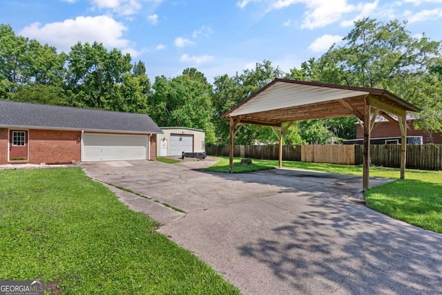 310 Ridge Rd, Kingsland, GA 31548 - exterior space featuring driveway, a garage, brick siding, a carport, and an outdoor structure