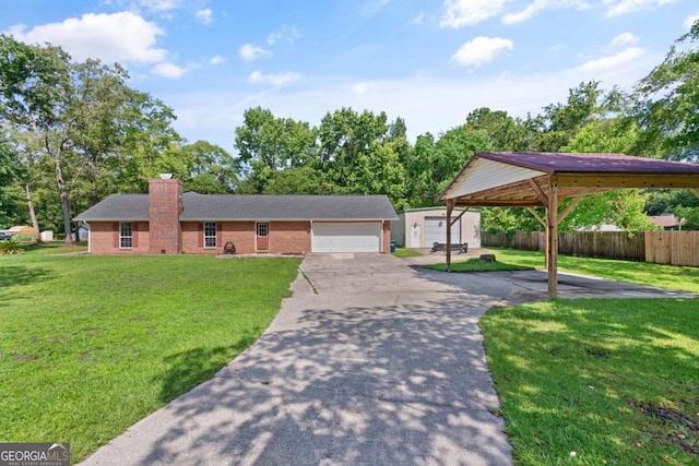310 Ridge Rd, Kingsland, GA 31548 - ranch-style house featuring a chimney, brick siding, asphalt driveway, and an outbuilding