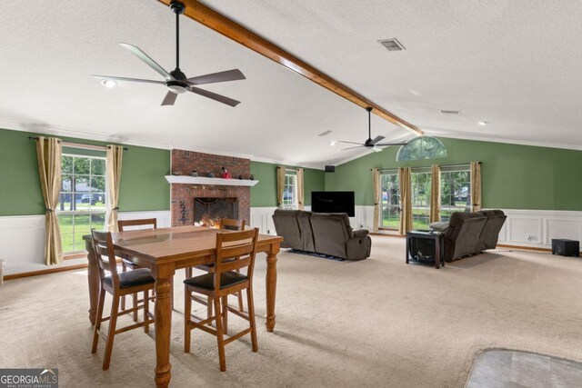 310 Ridge Rd, Kingsland, GA 31548 - carpeted dining area with ceiling fan, a wainscoted wall, a brick fireplace, a textured ceiling, and a decorative wall