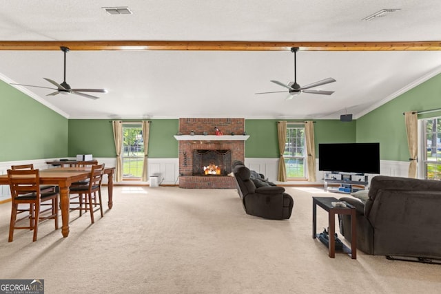 310 Ridge Rd, Kingsland, GA 31548 - carpeted living area featuring ceiling fan, a wainscoted wall, ornamental molding, and a fireplace