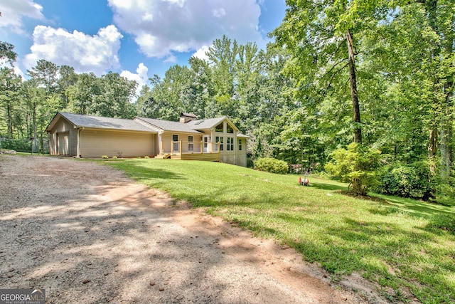 351 Weldon Rd, Palmetto, GA 30268 - view of front facade featuring driveway, a front lawn, an attached garage, and a chimney