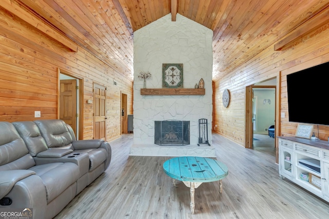 351 Weldon Rd, Palmetto, GA 30268 - living area featuring wood walls, a wooden ceiling with exposed beams, a fireplace, high vaulted ceiling, and wood finished floors