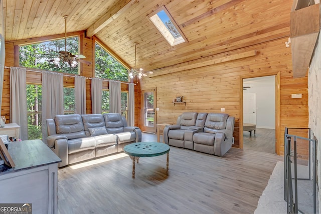 351 Weldon Rd, Palmetto, GA 30268 - living room featuring wooden walls, a skylight, high vaulted ceiling, wood finished floors, and a chandelier
