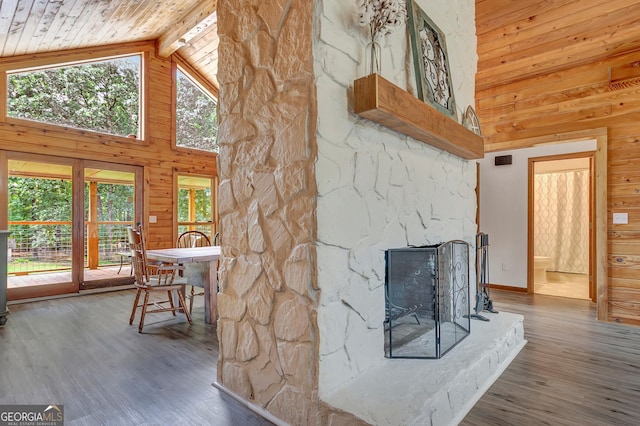 351 Weldon Rd, Palmetto, GA 30268 - living area with high vaulted ceiling, wooden walls, a wood ceiling with exposed beams, wood finished floors, and a fireplace