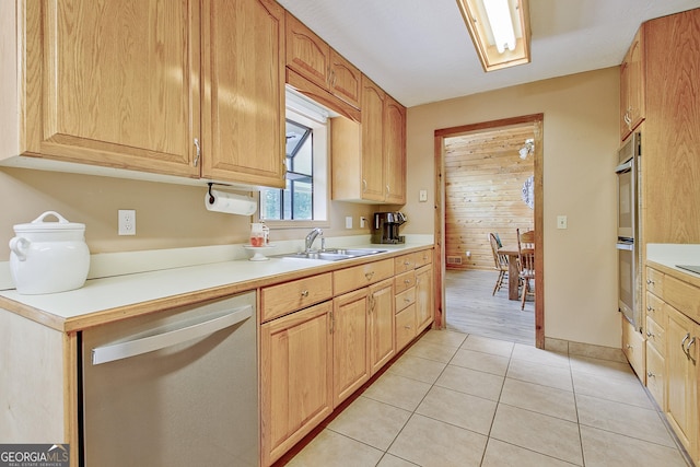 351 Weldon Rd, Palmetto, GA 30268 - kitchen with stainless steel dishwasher, light countertops, light tile patterned floors, and light brown cabinets